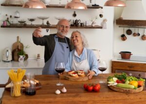 elderly couple taking a selfie while cooking