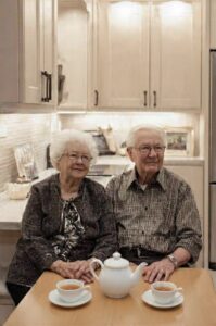 elderly couple sitting in a neat and tidy kitchen
